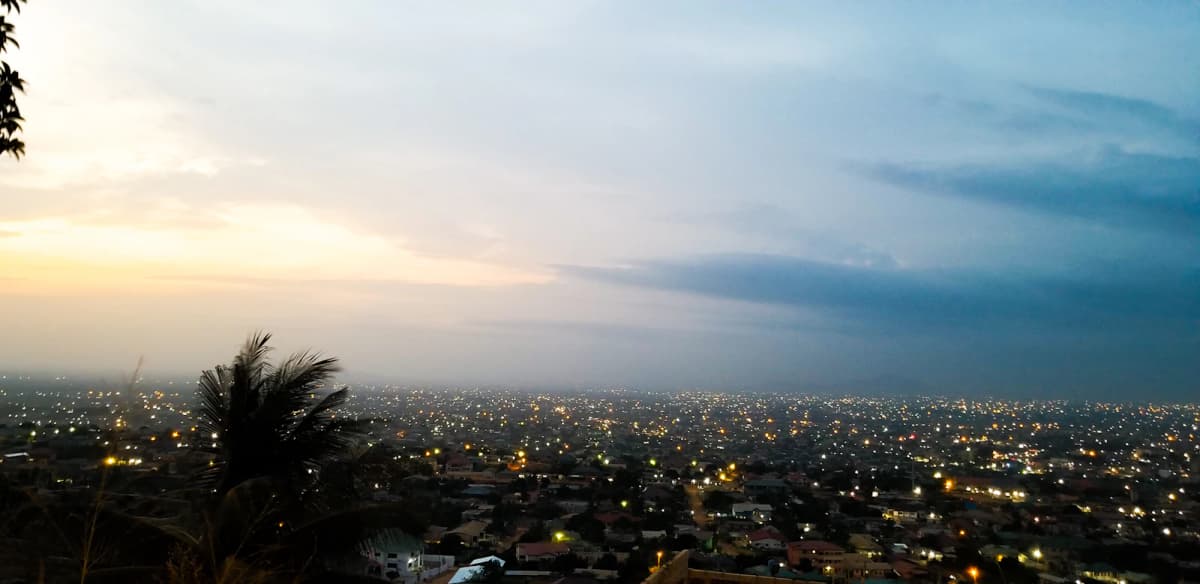 The lights of Accra spreading to the horizon at dusk